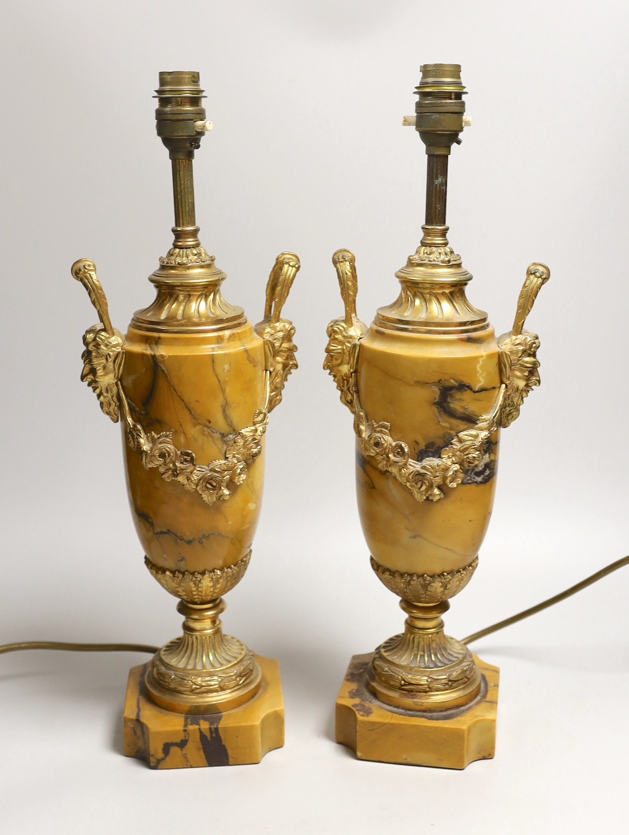 A pair of neo classical revival gilt metal and Siena marble lamps, 43cms high including light fitting